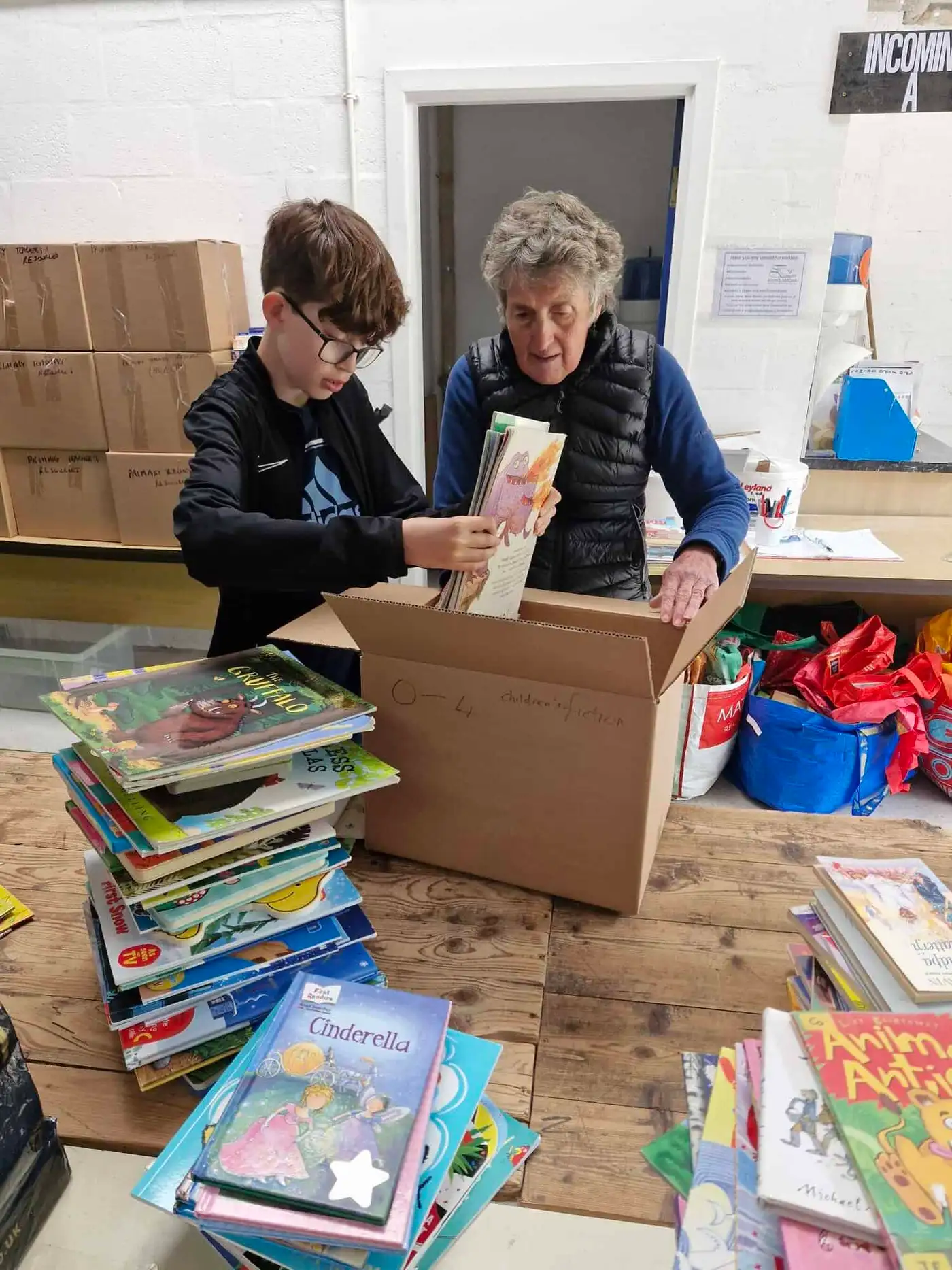 Grayson helping pack books