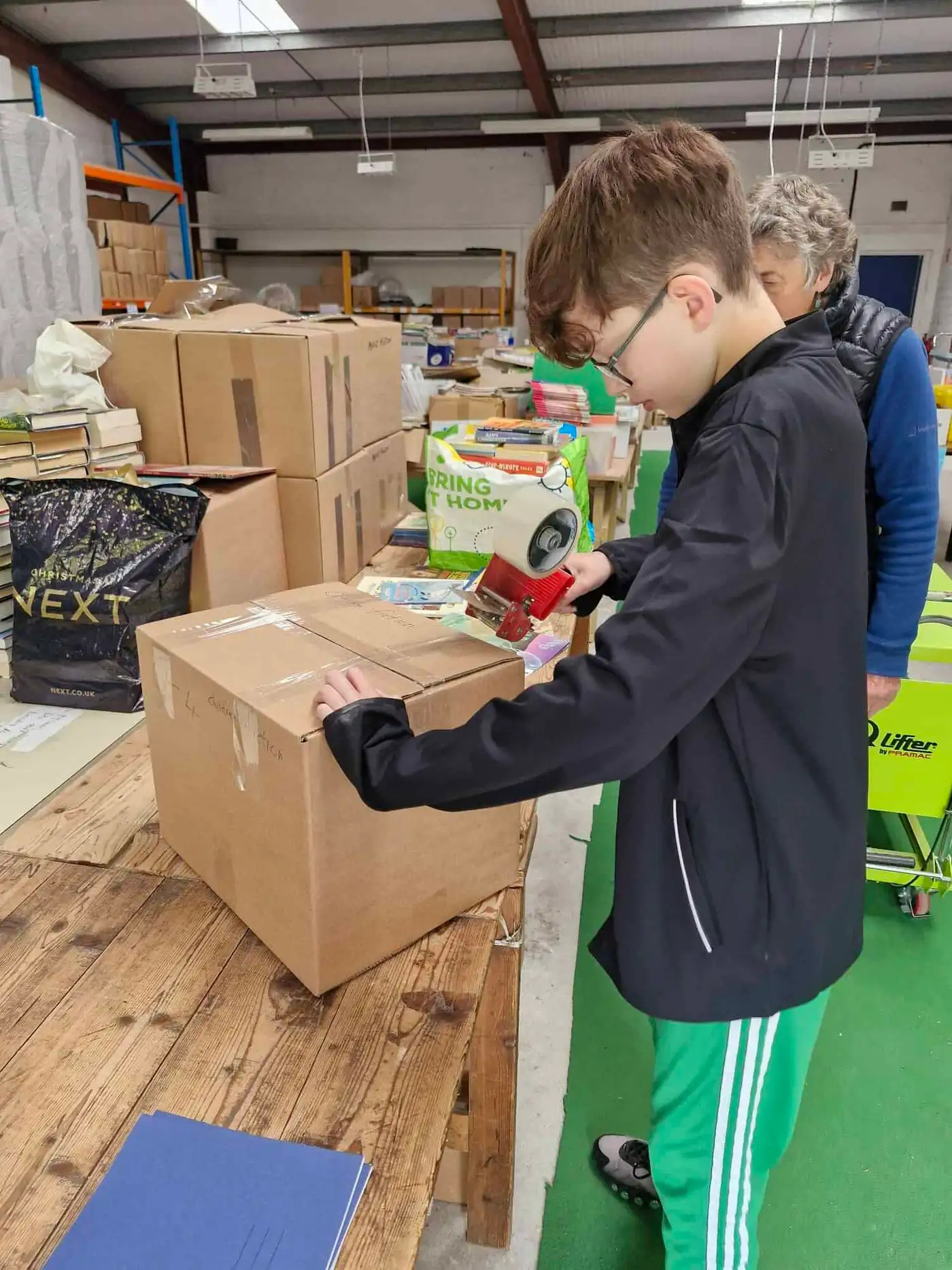 Grayson helping pack books